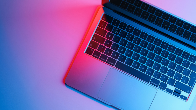 a laptop in blue and pink light