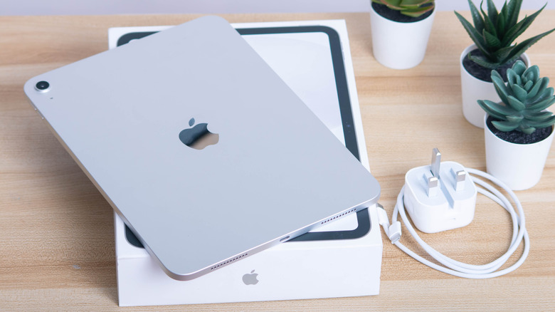 iPad (11th generation) placed next to its packaging box