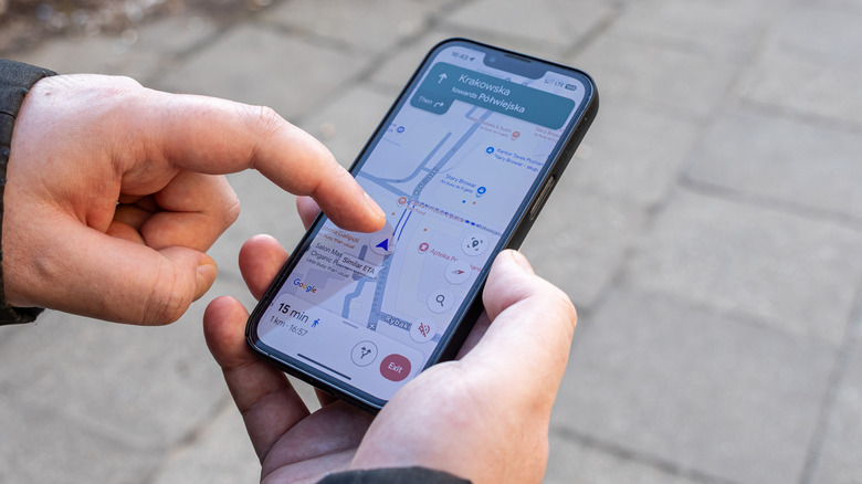 Two hands using Google Maps for navigation