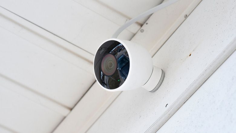 A closeup of a Google Nest camera on a porch.