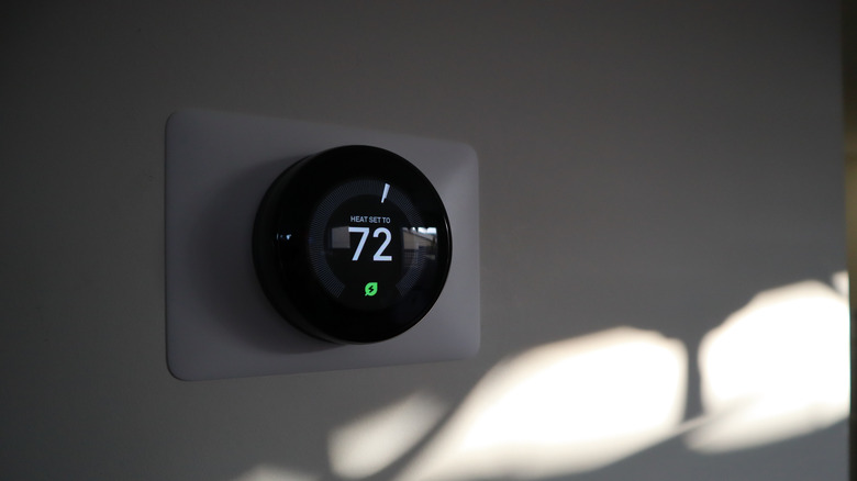 the Google Nest Thermostat mounted on a wall with the heat set to 72