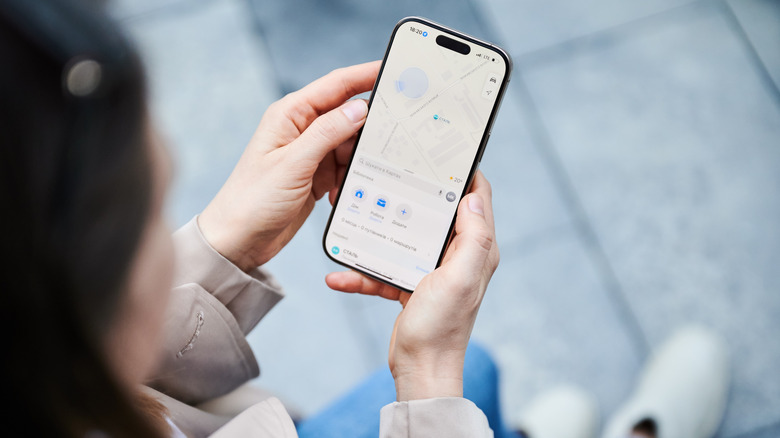 Close-up of a woman using an iPhone 16