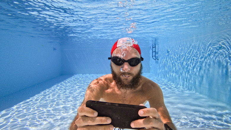 Man holding an iPhone underwater