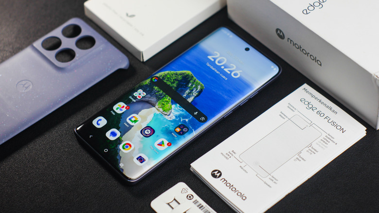 Motorola Edge Fusion on a table surrounded by the packaging.