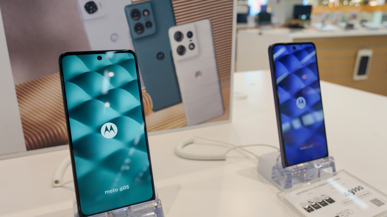 Two new Motorola phones in a shop window.