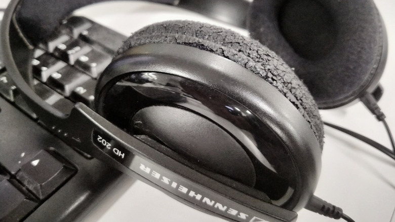 Close-up of worn foam pads on Sennheiser headphones.