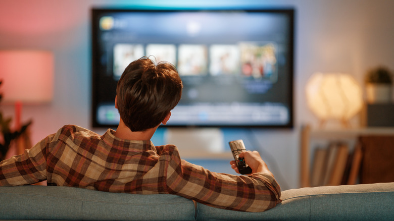 A man watching TV in his living room