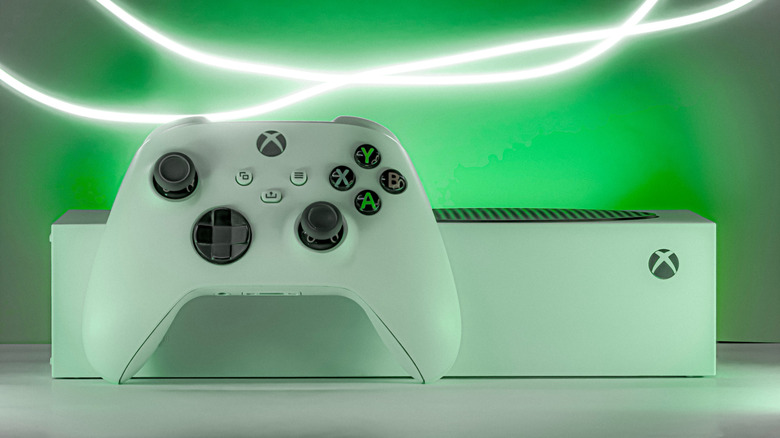 Xbox console with a controller in a fluorescent background