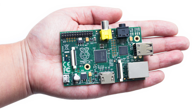 Raspberry Pi modular computer held in the palm of someone's hand.
