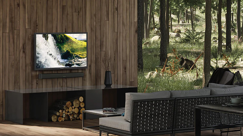 A Furrion outdoor TV mounted on wood paneling on an outdoor patio.