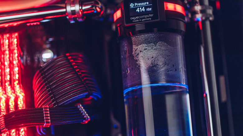 A water cooling system in a PC, lit with RGB lights.