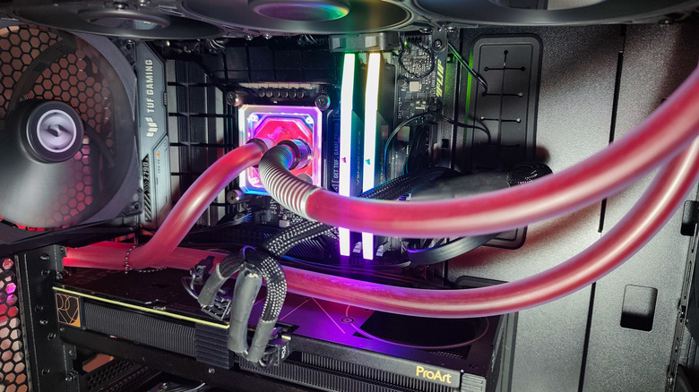 Close up of the inside of a custom PC with liquid cooling pipes connected to CPU cooler.