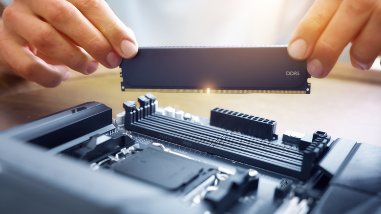 Person installing RAM onto motherboard