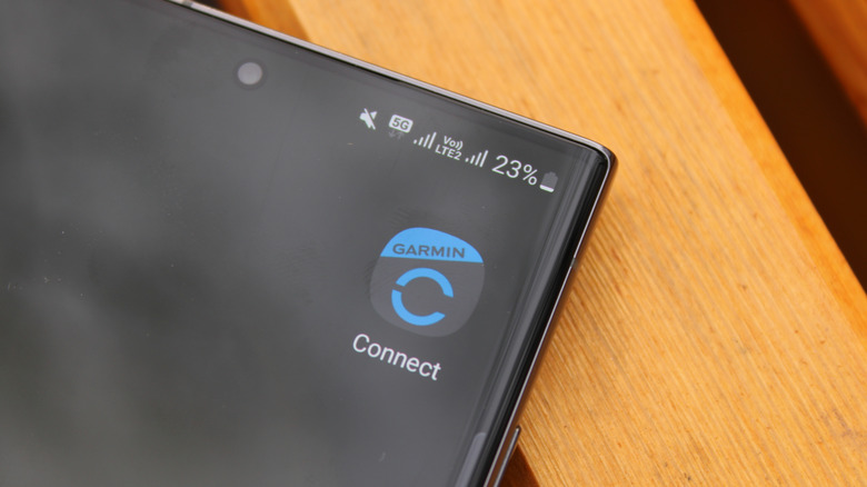 A closeup of a smartphone showing the Garmin Connect app icon.