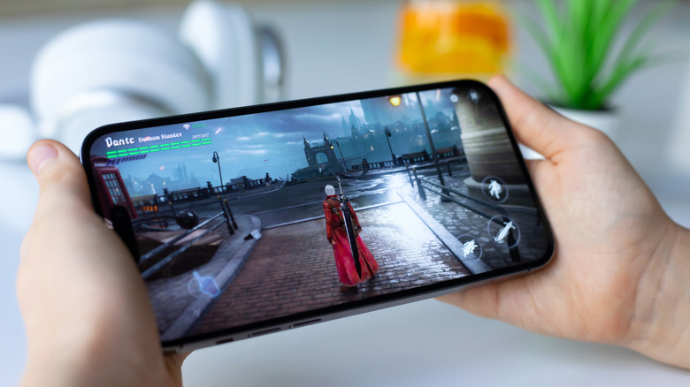 A person gaming on an iPhone.