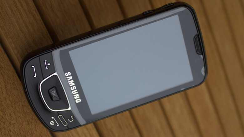Samsung Galaxy I7500 on wooden table with screen off.