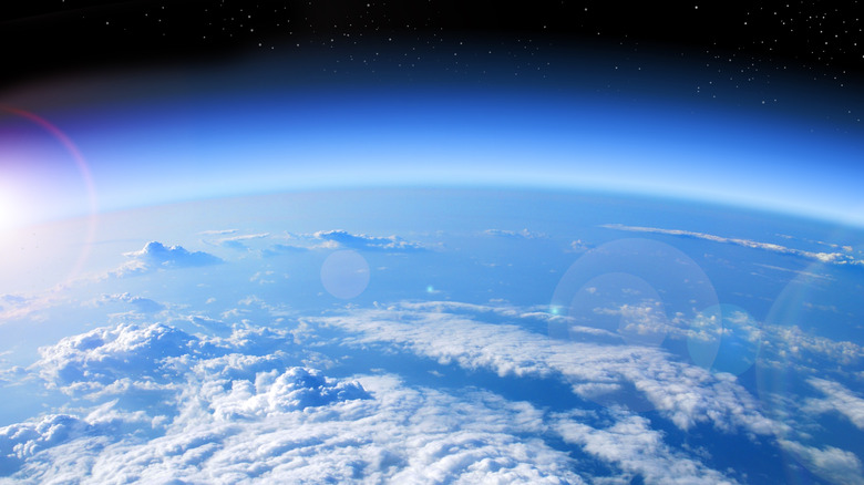 view of Earth from space showing cloudy atmosphere