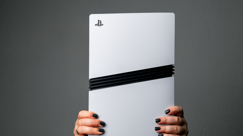 A person holding a PS5 Pro