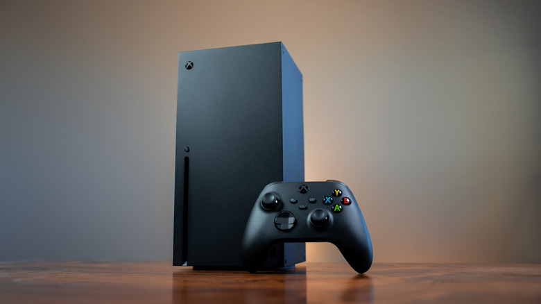 Xbox Series X console and controller on a wooden table
