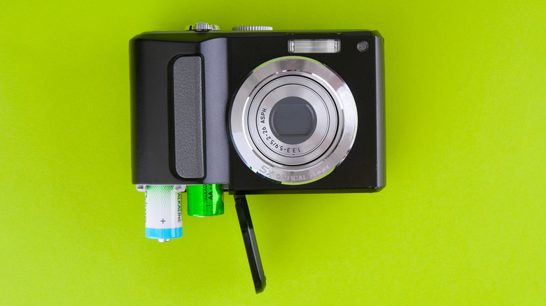 Front view of digital camera with two AA batteries inside