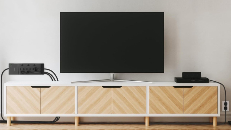 A Belkin surge protector connected to a TV and AV components.