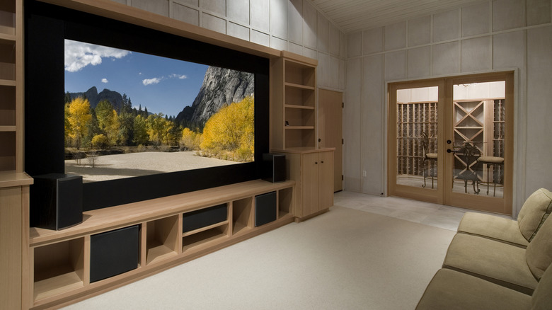 a home theater with subwoofers and other speakers around the TV