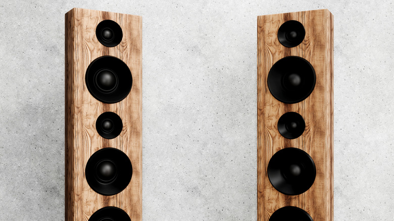 A pair of floor-standing, woodgrain speakers.