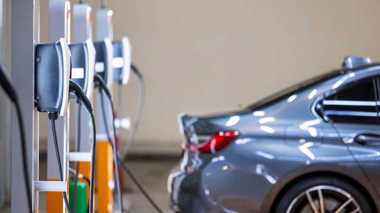an electric vehicle charging at a station