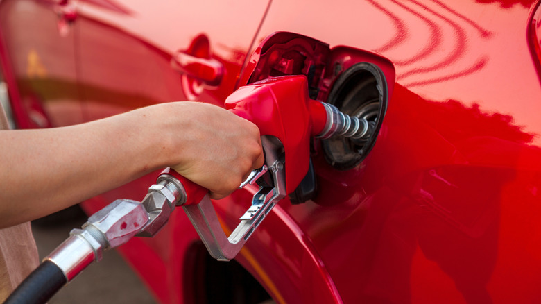 a person filling up their gas car at the pump
