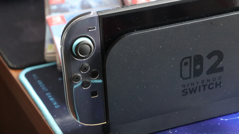 Black Nintendo Switch 2 with protective Joy Con case in charging dock