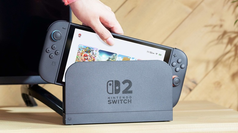 Person removing Nintendo Switch 2 from dock