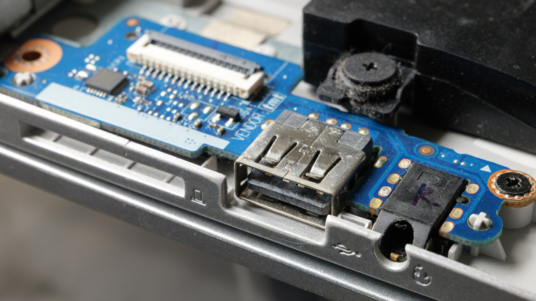 Laptop with the outer casing removed, leaving the USB port exposed