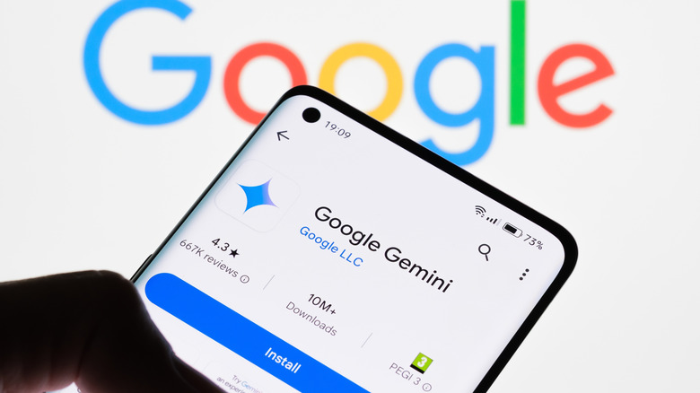 The Google Gemini app open on a phone with the Google logo in the background
