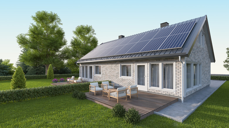 A white brick home with solar panels on the roof