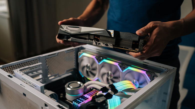 Man building PC Inserting Part