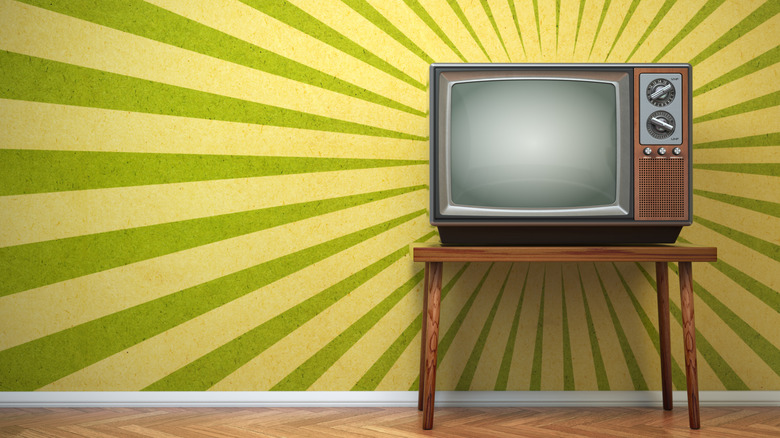 An old CRT TV on a wooden table.