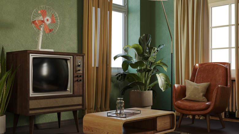 An antiquated-looking living room, which includes an old-looking TV.