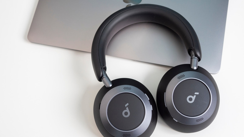 Soundcore headphones on top of a Macbook Air laptop