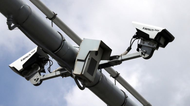 Toll cameras against a cloudy backdrop