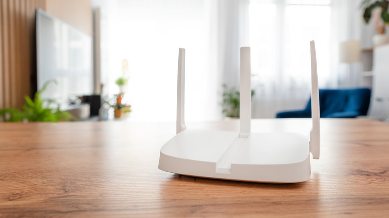 A white router sitting on a wooden table