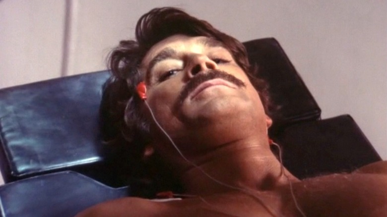 A close up of Alex Cord as Dylan Hunt in Genesis II, he lies on a table with sensors attached to his head