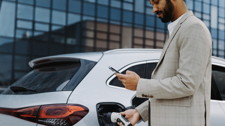 A person charging his electric vehicle