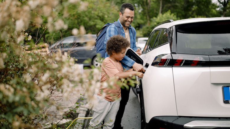 Family plugging in EV to charge