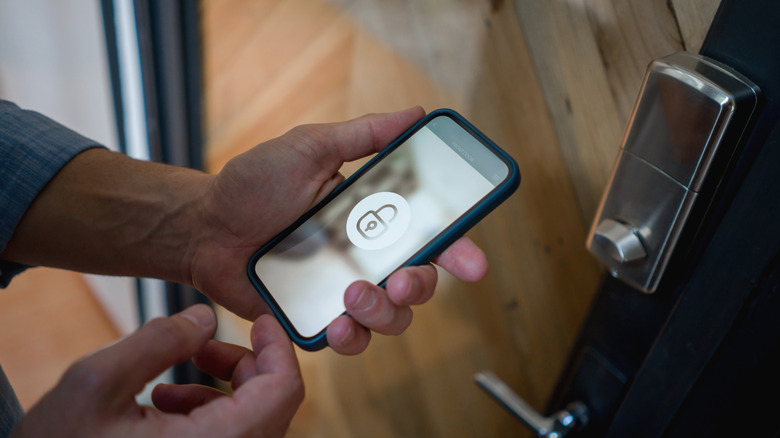 Man using smartphone to open smart lock