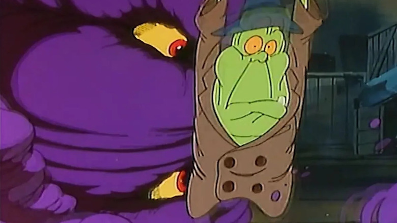 Slimer wearing a trenchcoat and looking scared next to a purple monster with big eyes