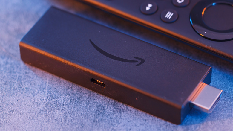 An Amazon Fire TV Stick placed next to its remote.