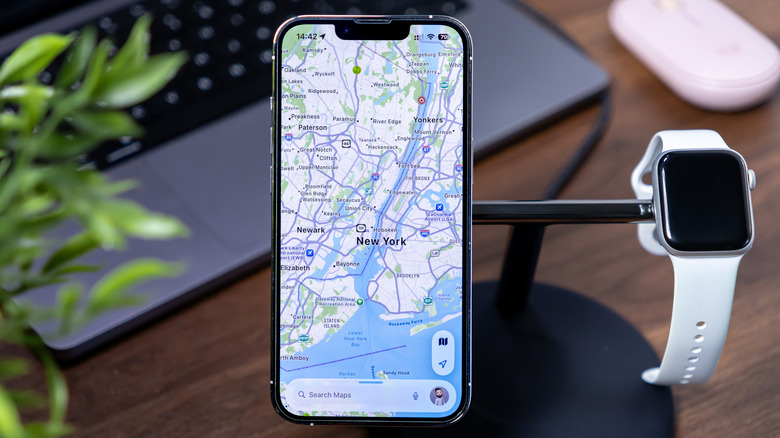Apple Maps loaded on an iPhone placed on a charging stand.