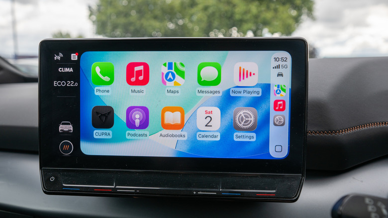 Apple CarPlay home screen with a blue wallpaper