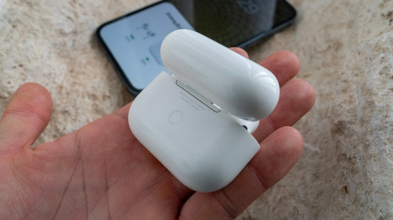 AirPods Pro Wireless earbuds shown with charging case in front of a smartphone
