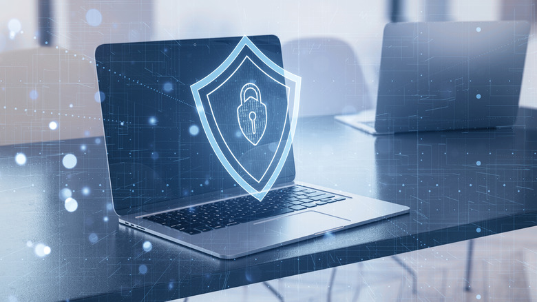 A security icon over a laptop.